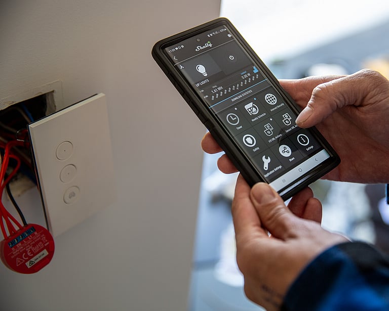 An image of a technician adjusting network settings on a device.