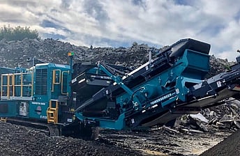 close-up of Powerscreen Trakpactor 260SR rock crushing machine in concrete recycling yard