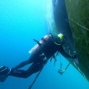 Diver working on vessel offshore