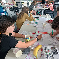 Students engaged in a hands-on sustainability learning activity