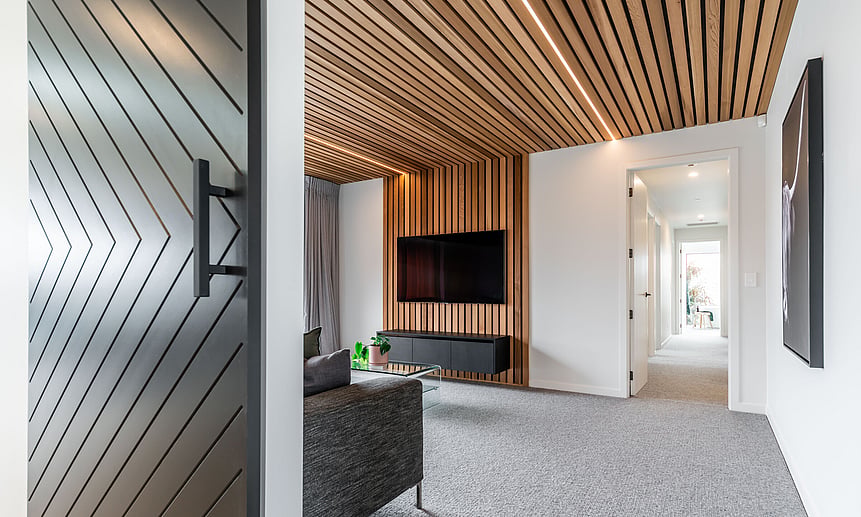 Cleverly designed lines adorn this entertainment room with wooden ceiling panel & strip lighting built by Linecrest Homes.