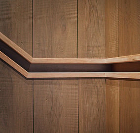Staircase handrail detail with timber treads and a minimalist balustrade in the Ocean Beach Road architectural coastal home in Mount Maunganui, built by Tauranga architectural builders MB Construction.