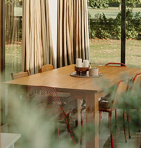 Interior dining detail in a barn-style architectural rural home near Matamata with timber finishes and large glazing to the rural outlook, built by MB Construction, residential builders for Matamata and the Bay of Plenty.