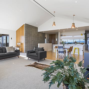 Open plan kitchen dining and lounge area. Modern design with high pitched a-frame ceiling.