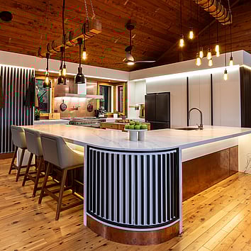 Modern white kitchen with timber flooring and timber ceiling. 