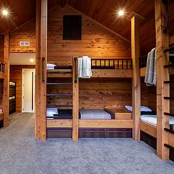 built-in timber beds in a rustic timber bedroom.