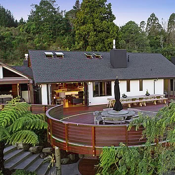 Large family home with deck nestled in New Zealand native bush.