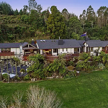 Arial view of large family home surrounded by New Zealand native bush.