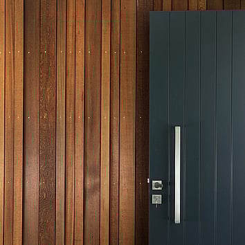 Internal timber cladding and black front door 