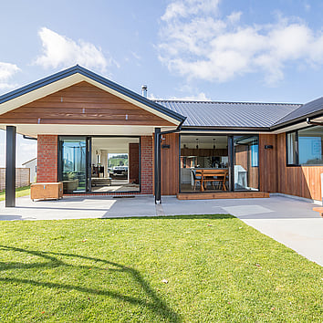 Red Brick home with concrete patio.