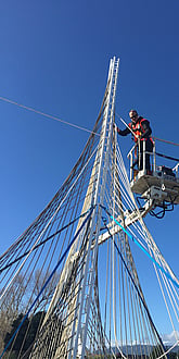 Ben Lowry Hoyle working at heights on the woven rope sculptures that form part of Te Huarahi landscape.