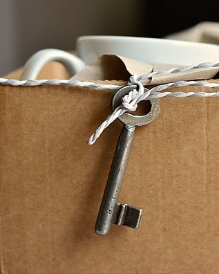 A packing box with a key hanging from a piece of string