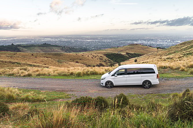 Luxury Exclusive Driver vehicle travelling along a scenic South Island country road