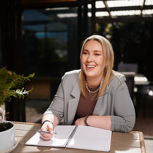 Picture of Amber smiling while taking notes