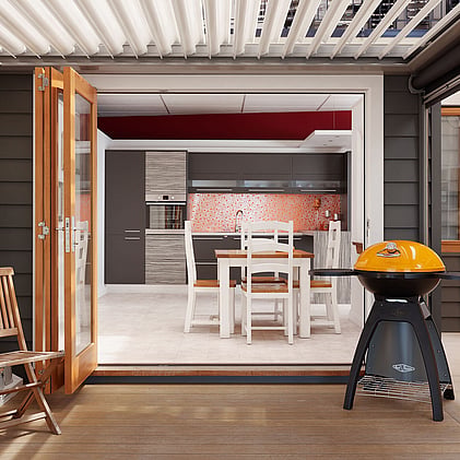 Modern kitchen in Barrett Joinery's Timaru showroom featuring custom cabinetry, bold orange backsplash, and innovative storage solutions, showcasing bespoke joinery for contemporary homes.