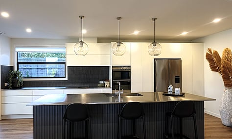 Industrial-inspired kitchen with polished concrete floors, designed by Barrett Joinery.