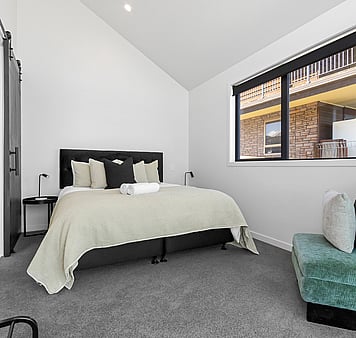 Super king bed in master bedroom in lakefront accommodation in Taupo, New Zealand