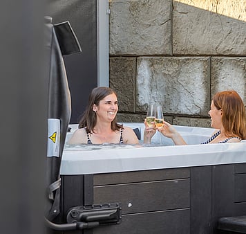 Two guests enjoying a spa pool at accommodation in Taupo
