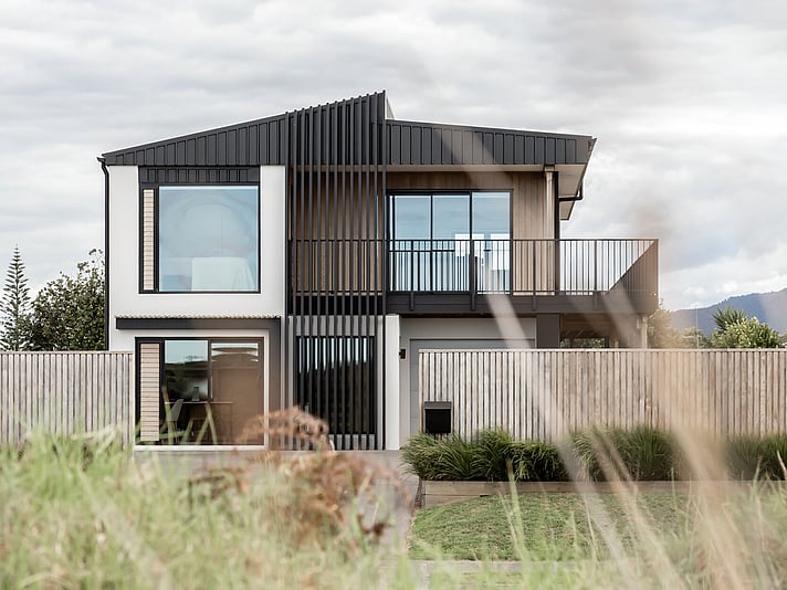 The project cover image shows a full home renovation of a two-story modern home in Papamoa Beach with new cladding, joinery, and a new roof profile, completed by Straight Up Builders Tauranga. 