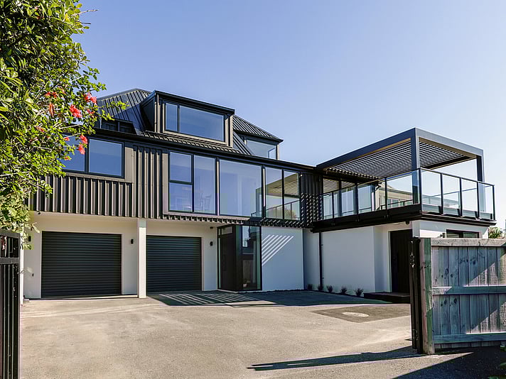 The project cover image shows a full home renovation of a two-story modern home in Papamoa Beach, featuring new cladding, joinery, outdoor decking with a louvered pergola, and a new roof, completed by Straight Up Builders Tauranga. 