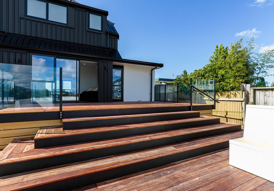 Image shows a new kwila timber deck, built at the back of a Papamoa Property,