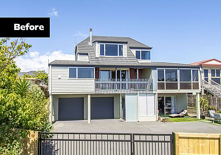 The image shows the property before the renovation build, featuring timber classing and old joinery, which needed updating. 