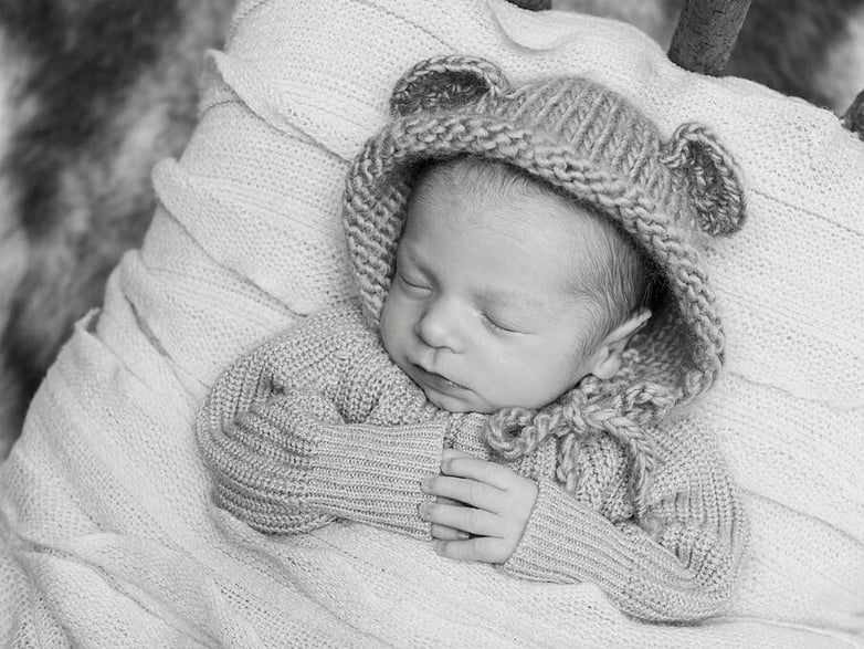 Newborn baby black and white photography with bear hat on