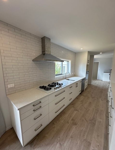 Kitchen Renovation with white stone bench and tiled splashback
