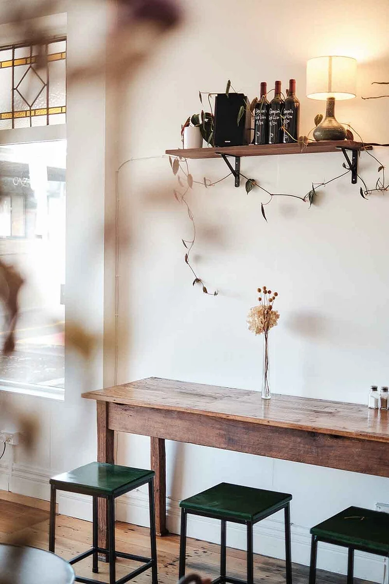 Interior of Auckland wine bar, with stools and shared table