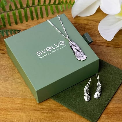 Green Evolve brand jewellery pouch and box with feather sterling silver pendant and earrings.