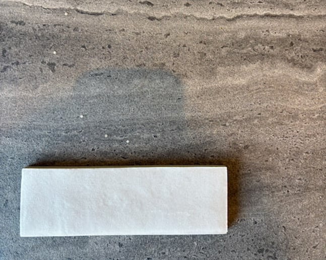 Dark grey tiles and textured cream tiles 