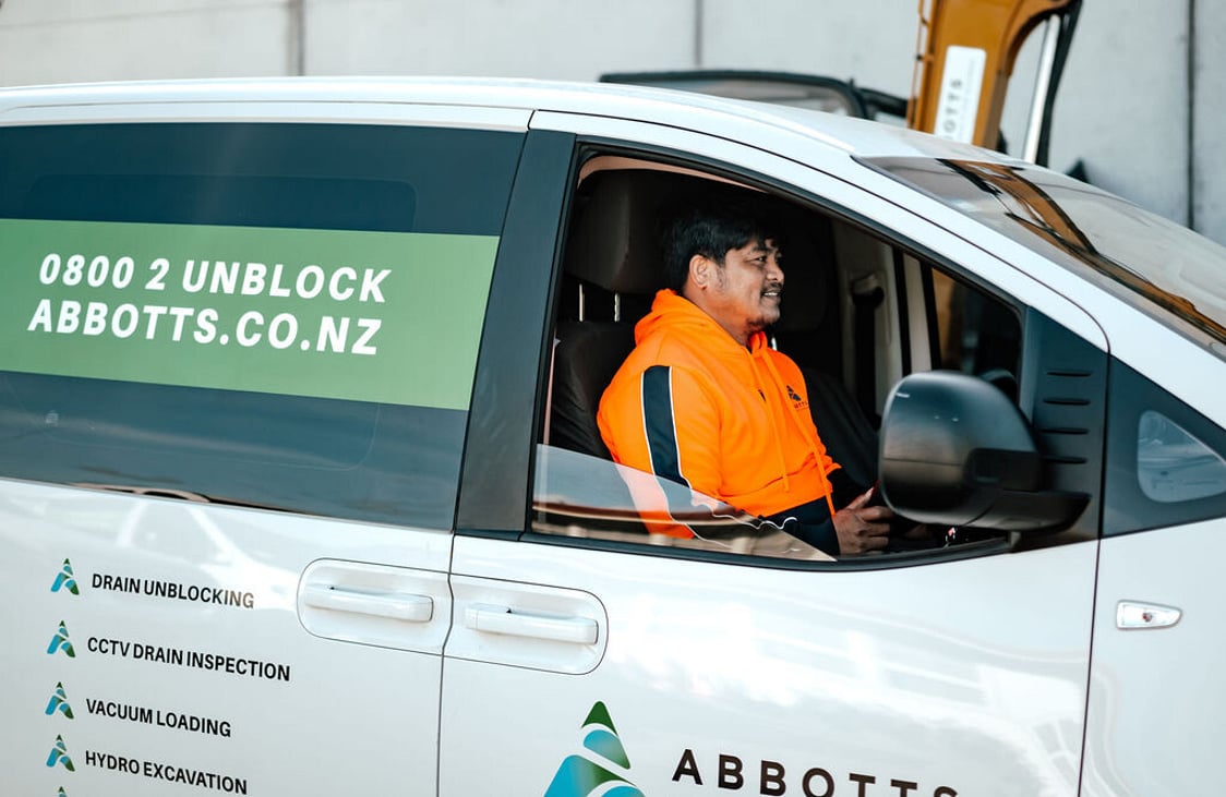 Abbotts drain unblocking technician in a branded Abbotts van