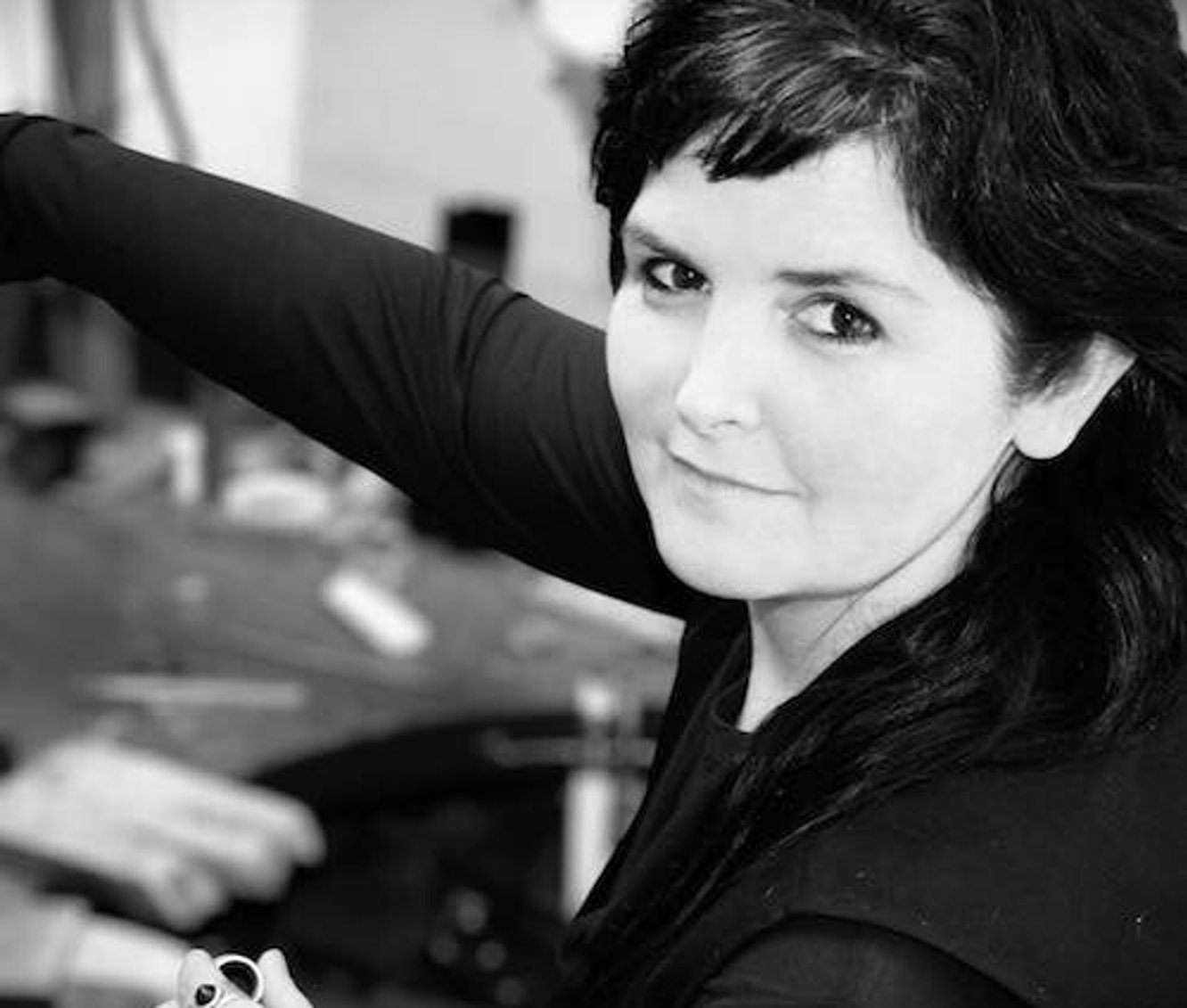 Jane Sutherland, New Zealand fashion designer and jewellery maker at her work bench creating.