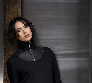 A model wearing a black Jane Sutherland scarf and statement necklace.