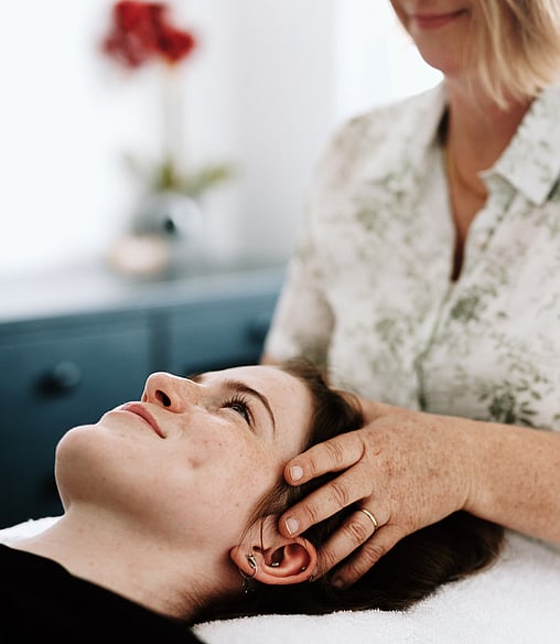 Image of Heather from Vital Body Therapy treating a client with Craniosacral Therapy. Cambridge clinic location, Waikato. New Zealand.