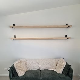 Custom timber shelving with wall brackets.