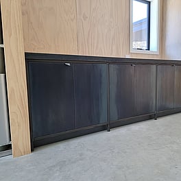  Laundry unit - hot rolled steel doors with steel framing to the face of the units. Tiled top.
