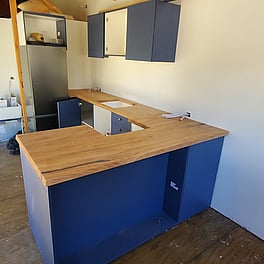 Tiny house kitchen with rimu bench tops.