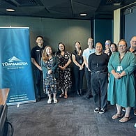 Team of professionals standing together at an awards or recognition event