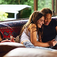 Two teenagers looking at ipad together