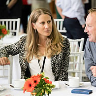 Two people at event seating at table talking
