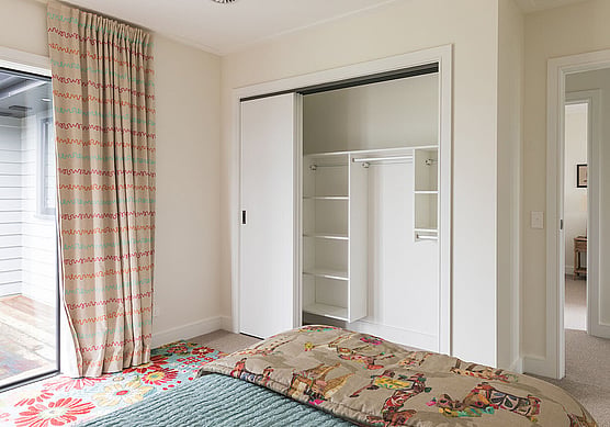 Fitted wardrobe with shelves in a children's bedroom.
