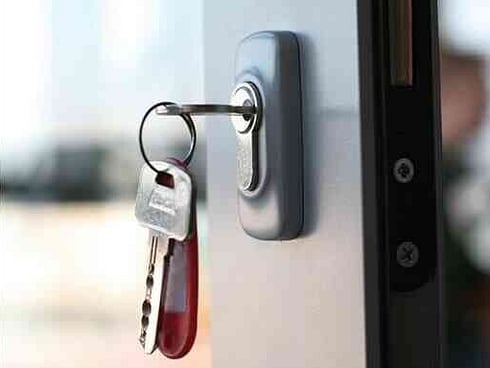 an open door and a bunch of keys hanging in lock