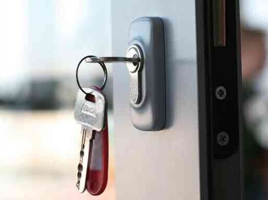 an open door and a bunch of keys hanging in lock