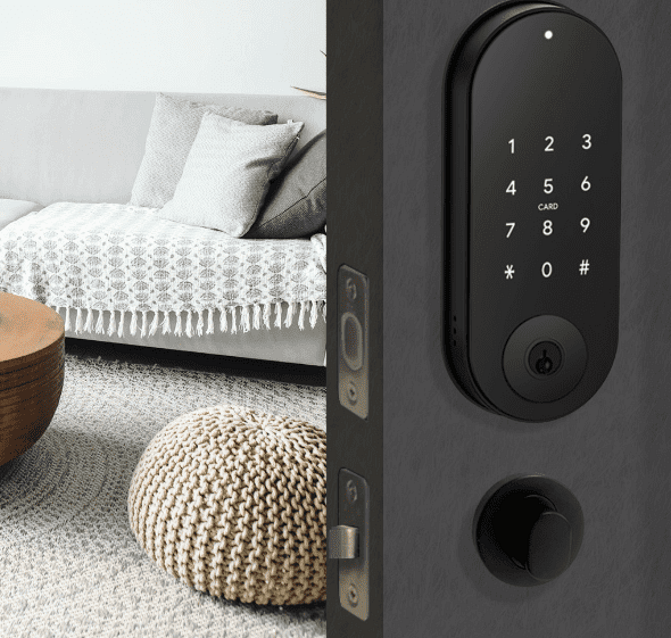 The Doorbot Digital Electronic Deadolt installed on a black door  with a furnished living room in the background.