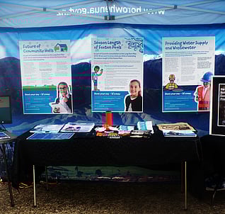 Table at consultation event with promotional items and information boards
