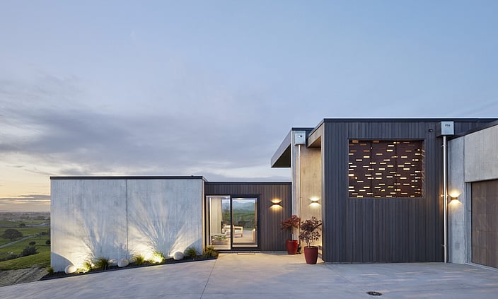 concrete and cedar house on hill