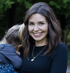 Jade Cox pictured with her young daughter snuggling into her shoulder Deputy Director of Counted NZ