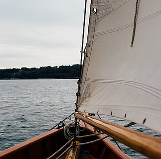 Sailboat symbolizing strategic governance development, representing the merger of Westlake Governance and Peakstone Global to form Global Governance Advisory (GGA) for better board performance.