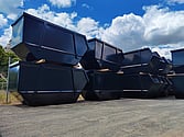 Photo of 12 out of 20 black powder coated skip bins